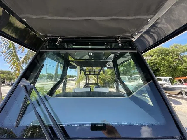 Slide: The Image of 2023 Blackfin 302CC boat windshield and cockpit view. - 25