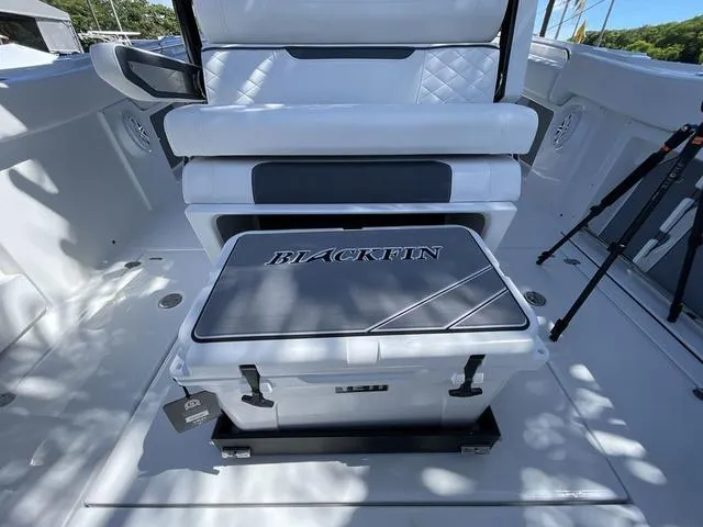 Slide: The Image of 2023 Blackfin 302CC boat interior with seating and storage. - 27