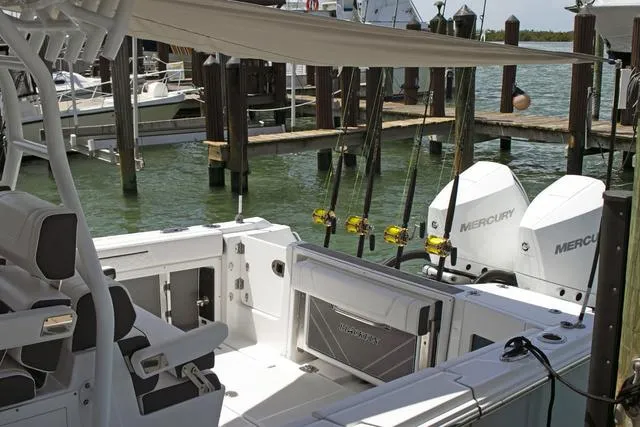 Slide: The Image of 2023 Blackfin 302CC boat with Mercury engines docked at marina. - 28