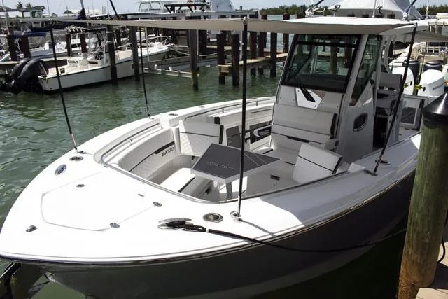 Slide: The Image of 2023 Blackfin 302CC boat docked at marina. - 31