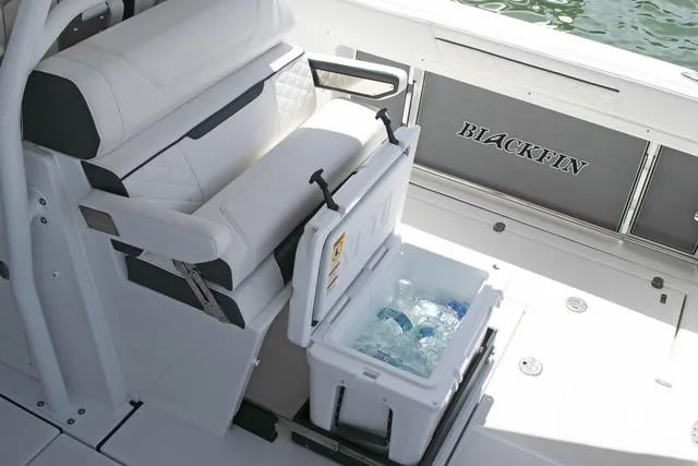 Slide: The Image of 2023 Blackfin 302CC boat interior with cooler and seating. - 33