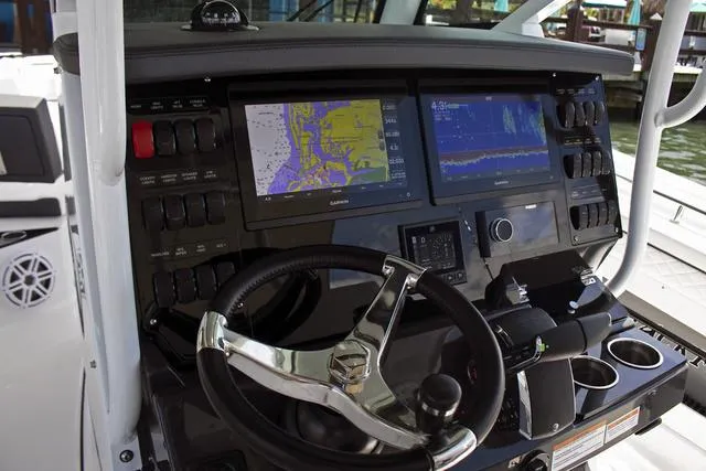 Slide: The Image of 2023 Blackfin 302CC boat dashboard with navigation screens and controls. - 37