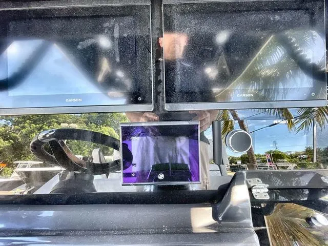 Slide: The Image of 2023 Blackfin 302CC boat dashboard with Garmin navigation screens. - 4