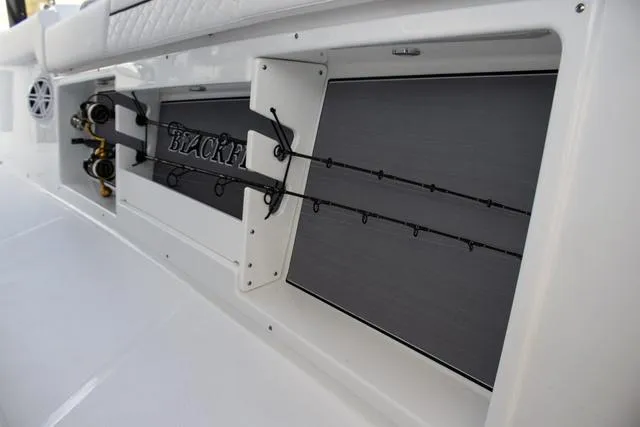 Slide: The Image of 2023 Blackfin 302CC boat with built-in fishing rod holders and storage. - 40