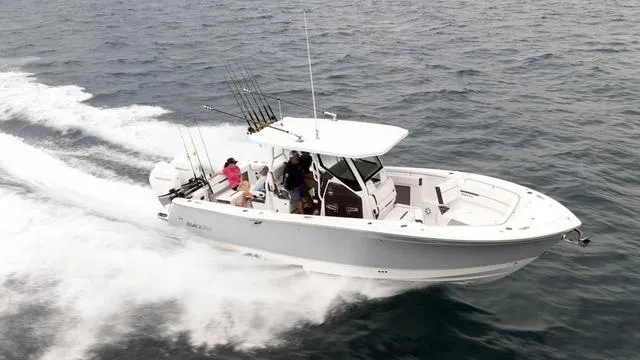 Slide: The Image of 2023 Blackfin 302CC boat cruising on the ocean with passengers. - 41