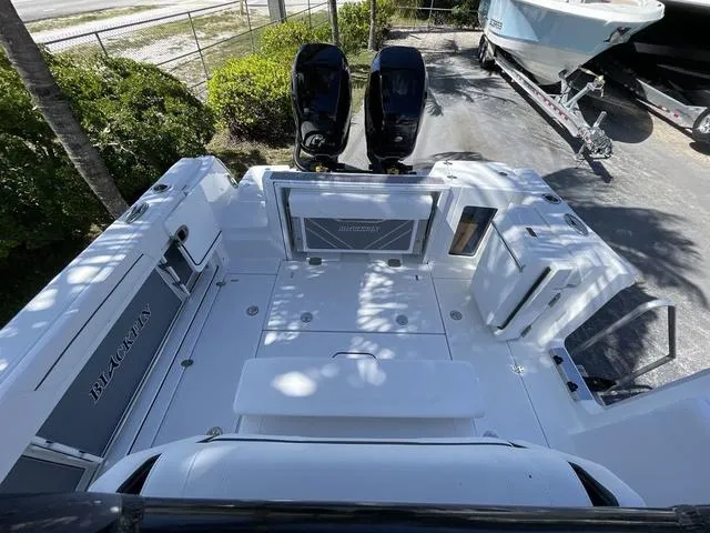 Slide: The Image of 2023 Blackfin 302CC boat deck with twin outboard motors. - 6