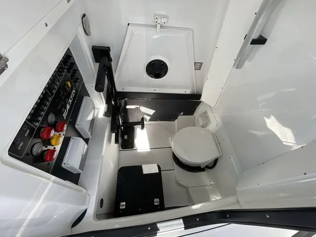 Slide: The Image of 2023 Blackfin 302CC boat interior with control panel and marine toilet. - 7