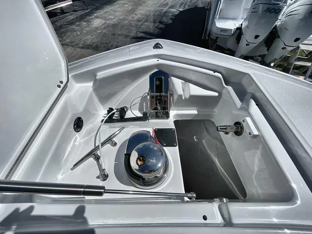 Slide: The Image of 2023 Blackfin 302CC boat anchor storage compartment with winch and accessories. - 8