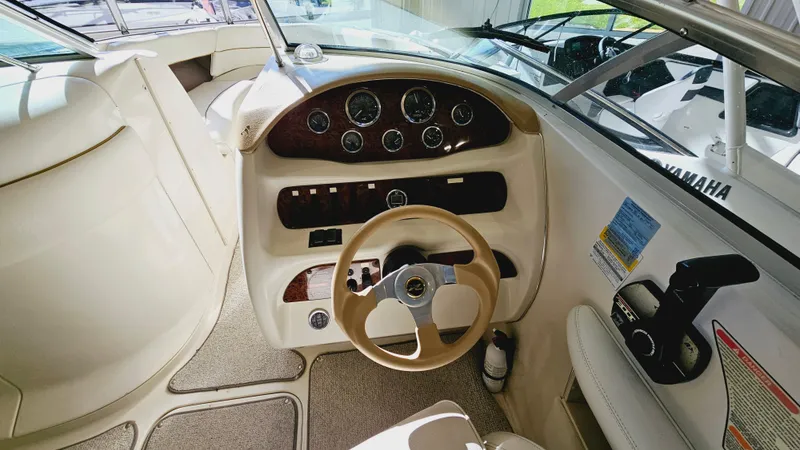 Slide: The Image of Interior cockpit of a 2000 Sea Ray 260 Bow Rider boat with steering wheel and control panel. - 10