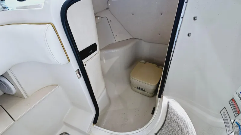 Slide: The Image of 2000 Sea Ray 260 Bow Rider interior cabin with portable toilet. - 12
