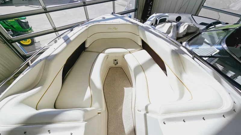 Slide: The Image of 2000 Sea Ray 260 Bow Rider interior with white cushioned seating. - 13