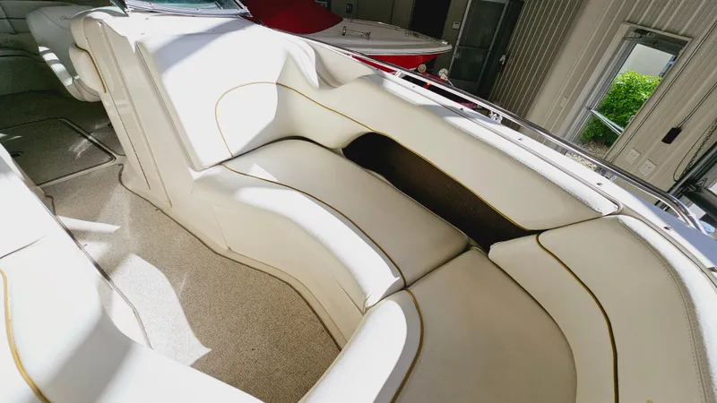 Slide: The Image of 2000 Sea Ray 260 Bow Rider interior with white leather seating. - 15