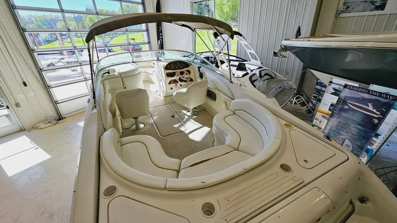 Slide: The Image of 2000 Sea Ray 260 Bow Rider boat interior in showroom. - 4