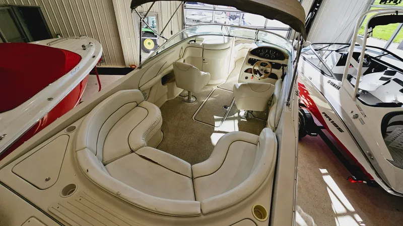 Slide: The Image of 2000 Sea Ray 260 Bow Rider boat interior with spacious seating and helm. - 5