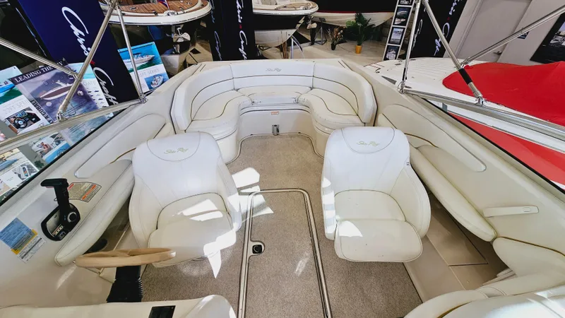 Slide: The Image of 2000 Sea Ray 260 Bow Rider interior with white leather seating and steering wheel. - 6