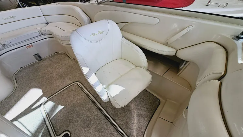 Slide: The Image of 2000 Sea Ray 260 Bow Rider interior with white leather seats and carpeted floor. - 8