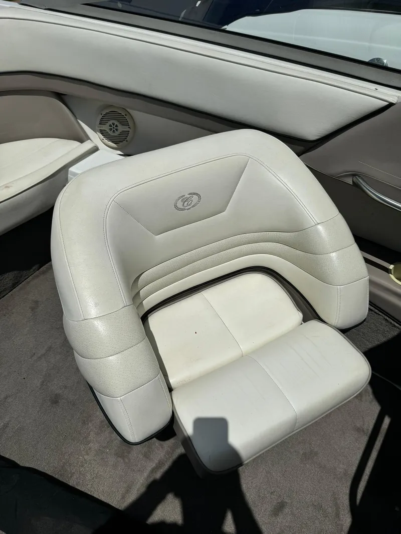 Slide: The Image of White leather seat in a 2000 Cobalt 252 boat interior. - 12