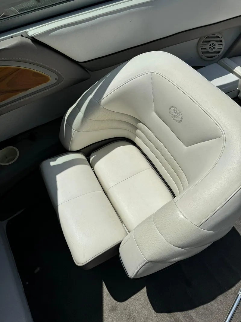 Slide: The Image of 2000 Cobalt 252 boat interior with white leather seating and speaker detail. - 13