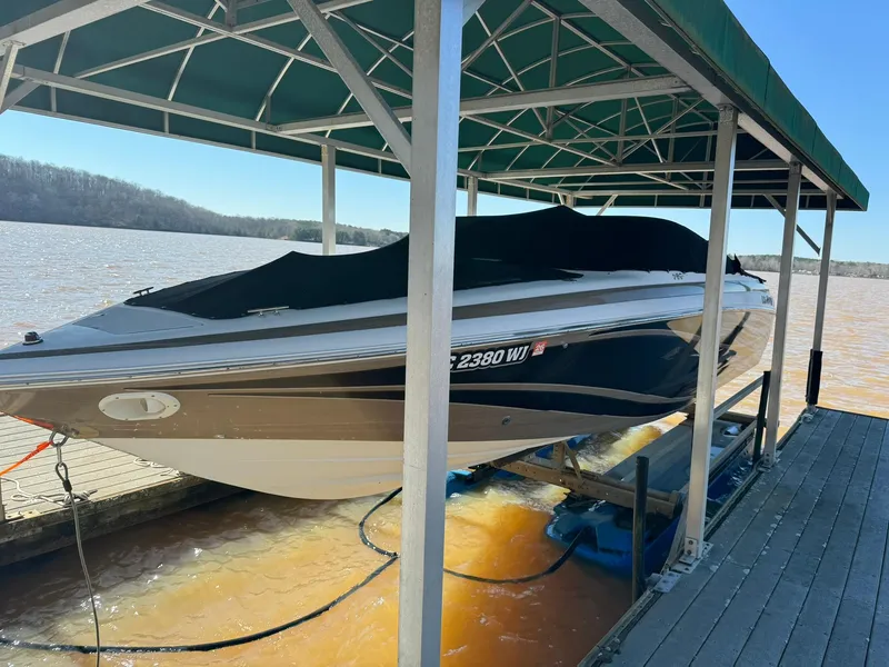 Slide: The Image of 2000 Cobalt 252 boat docked under a covered slip on a lake. - 3