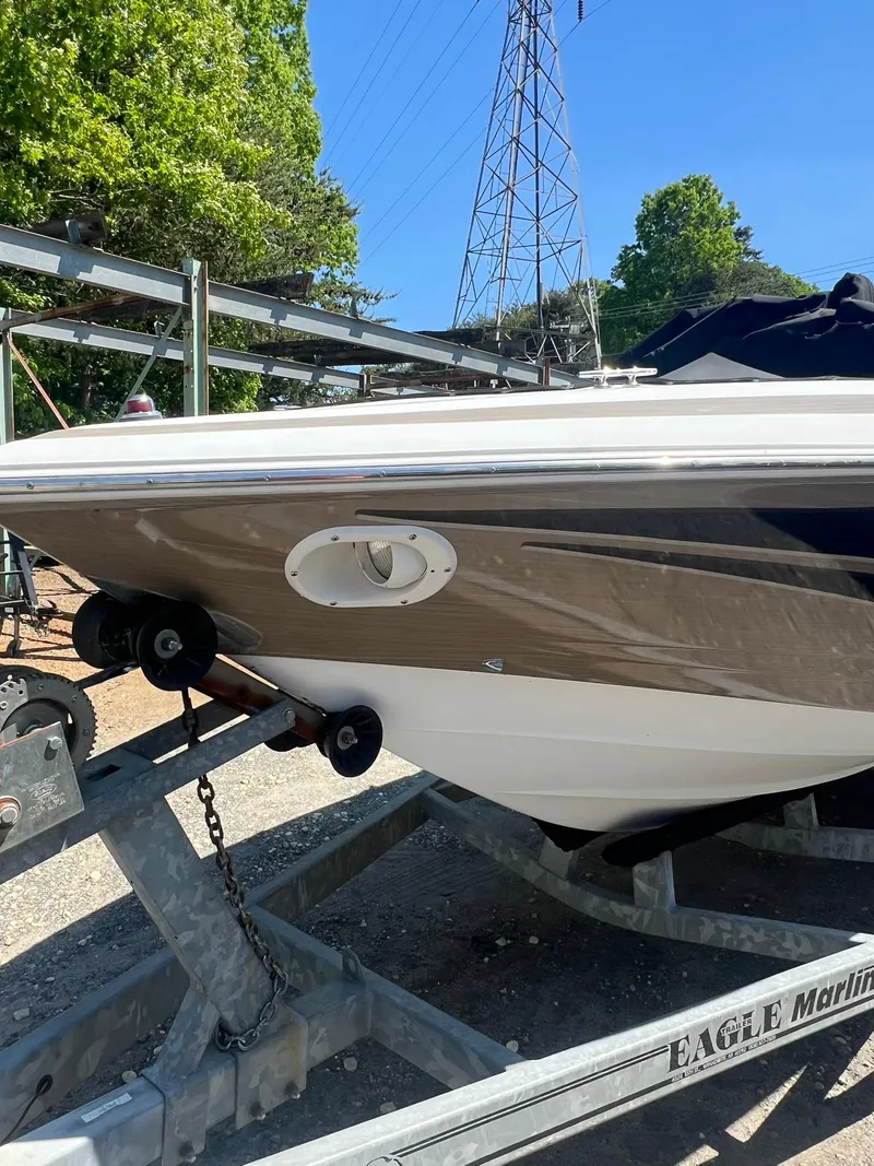 Slide: The Image of 2000 Cobalt 252 boat on a trailer at a marina. - 4