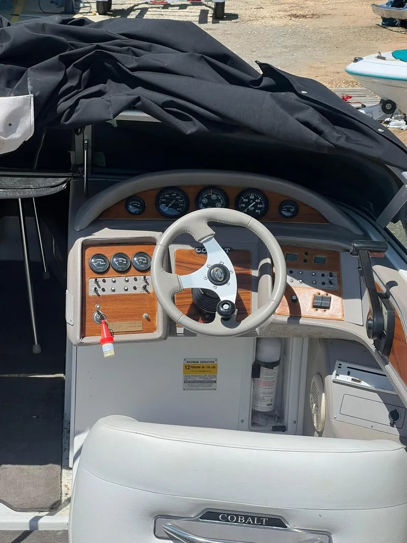 Slide: The Image of 2000 Cobalt 252 boat dashboard with steering wheel and control panel. - 7