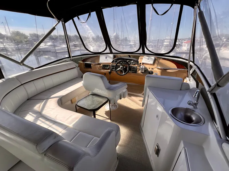 Slide: The Image of 2002 Carver 396 Motor Yacht interior with helm, seating, and sink. - 10