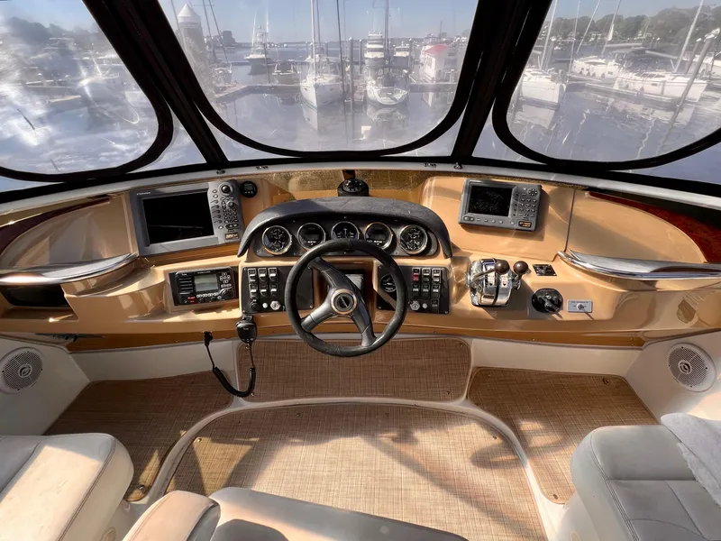 Slide: The Image of 2002 Carver 396 Motor Yacht helm station with navigation equipment and panoramic view. - 12