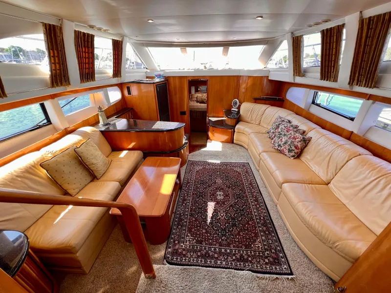 Slide: The Image of Luxurious interior of a 2002 Carver 396 Motor Yacht with leather seating and elegant decor. - 13
