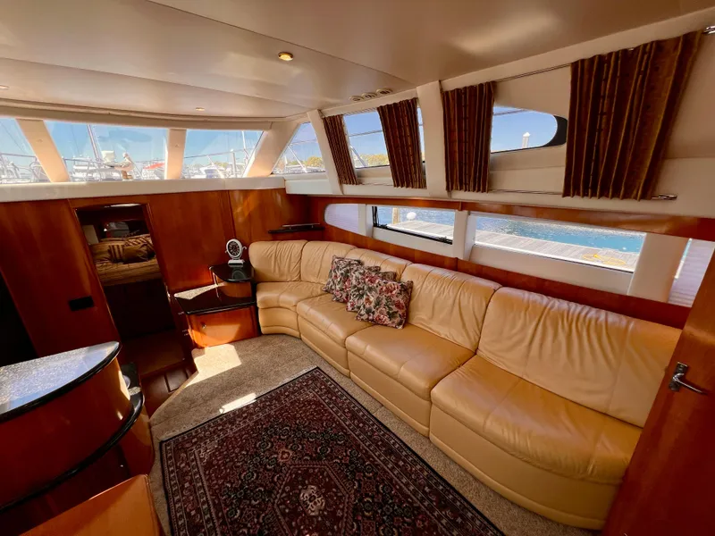 Slide: The Image of Luxurious interior of 2002 Carver 396 Motor Yacht with leather seating and large windows. - 14