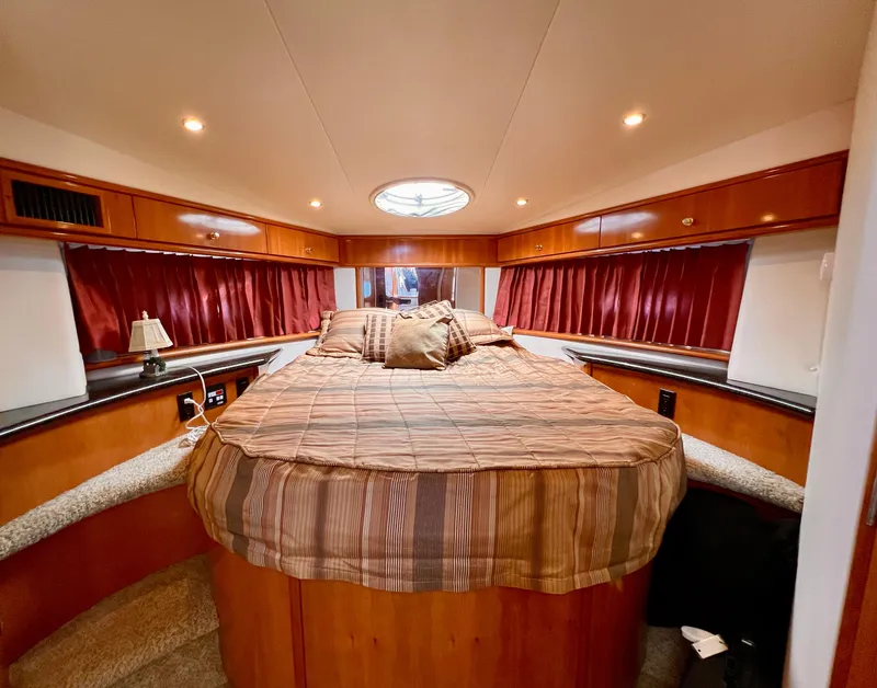 Slide: The Image of Luxurious bedroom interior of 2002 Carver 396 Motor Yacht with cozy bed and ambient lighting. - 18