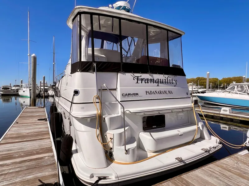 Slide: The Image of 2002 Carver 396 Motor Yacht Tranquility docked at a marina. - 2