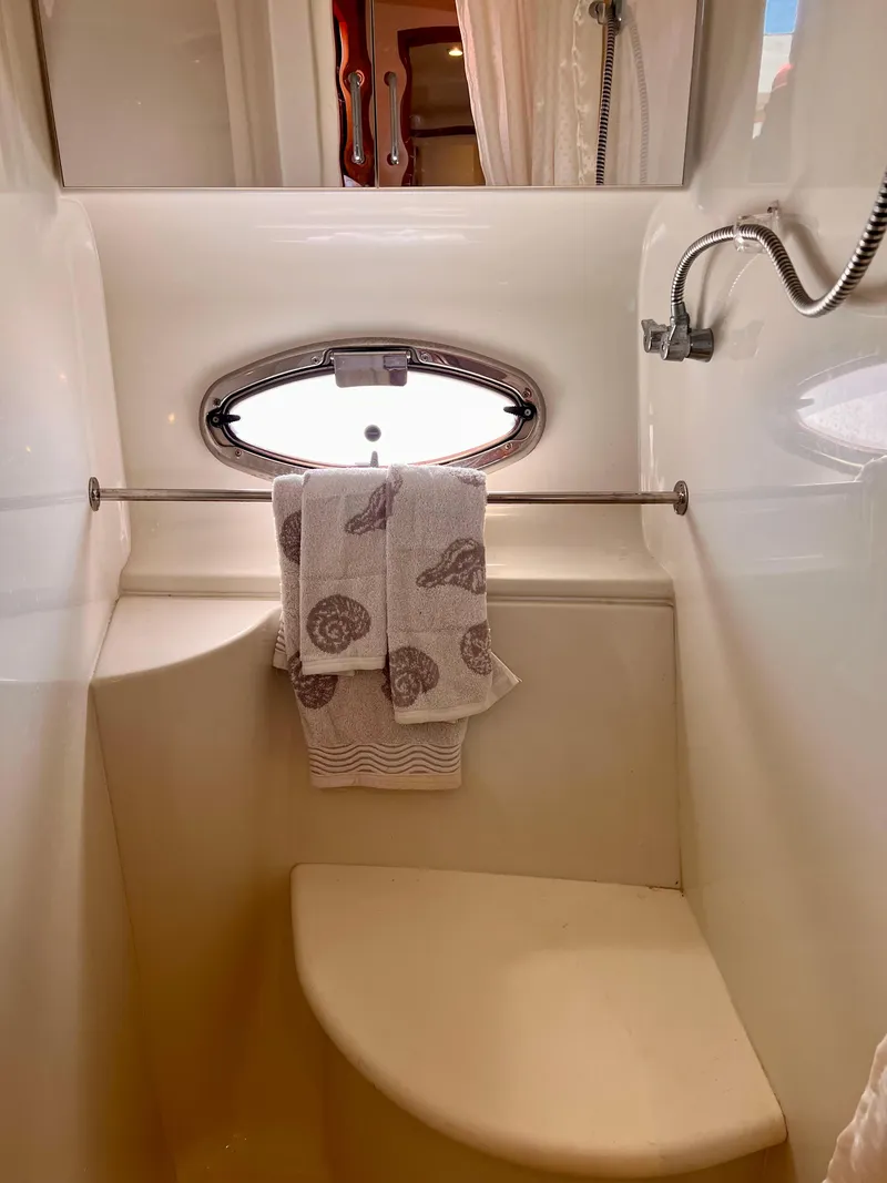 Slide: The Image of 2002 Carver 396 Motor Yacht bathroom with porthole window and towel rack. - 20