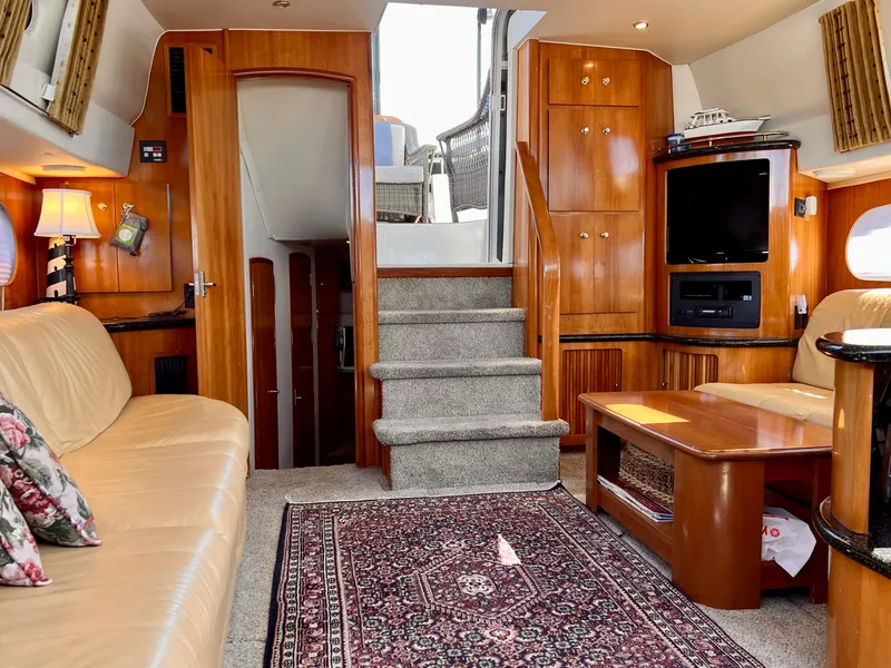 Slide: The Image of Interior of 2002 Carver 396 Motor Yacht with luxurious seating and entertainment area. - 21