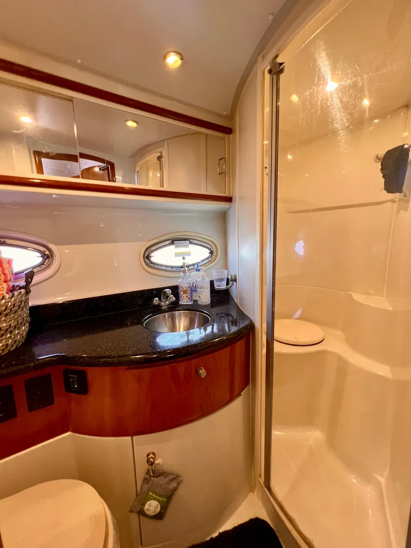 Slide: The Image of 2002 Carver 396 Motor Yacht bathroom with shower, sink, and storage. - 22