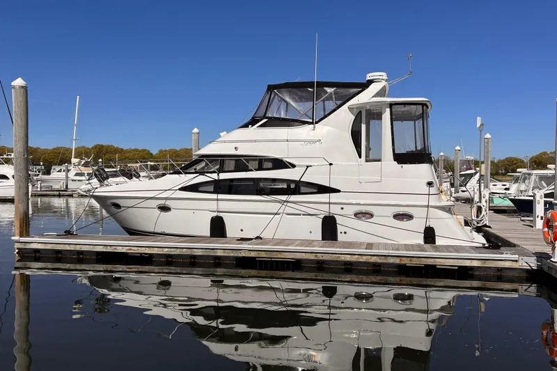 Slide: The Image of 2002 Carver 396 Motor Yacht docked at a marina on a clear day. - 25