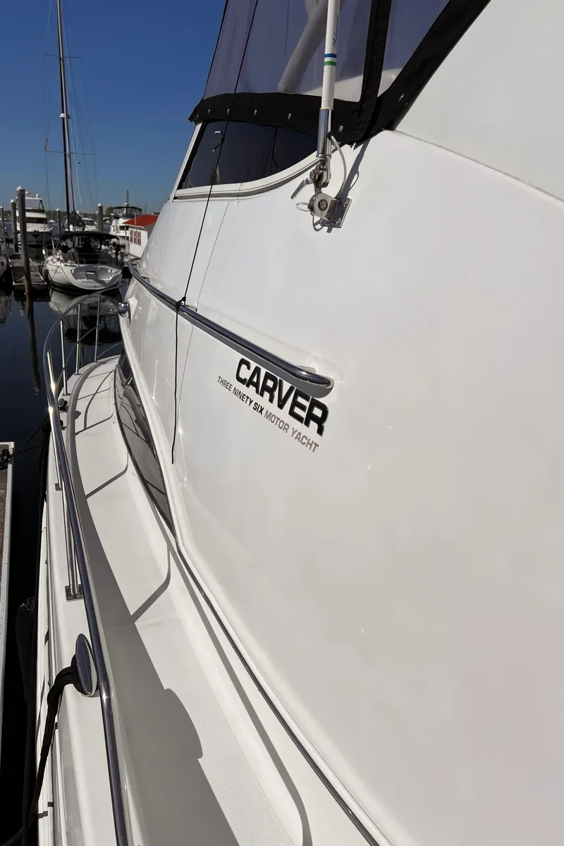 Slide: The Image of 2002 Carver 396 Motor Yacht docked at a marina. - 26