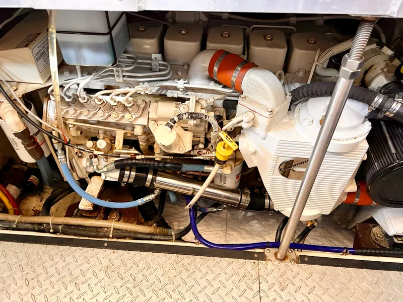 Slide: The Image of Engine compartment of a 2002 Carver 396 Motor Yacht showing detailed mechanical components. - 28