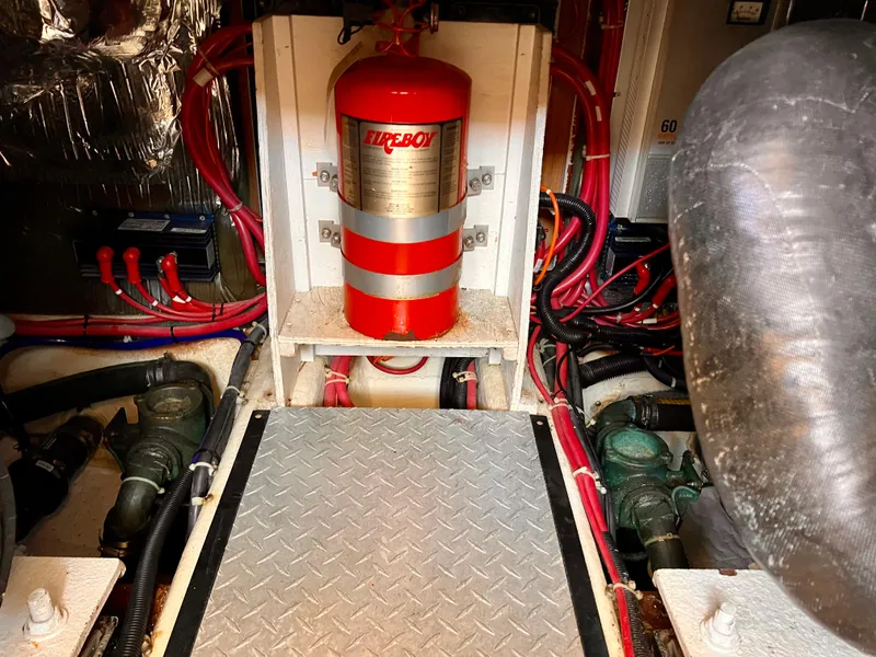 Slide: The Image of Engine room of a 2002 Carver 396 Motor Yacht with fire extinguisher and wiring. - 29