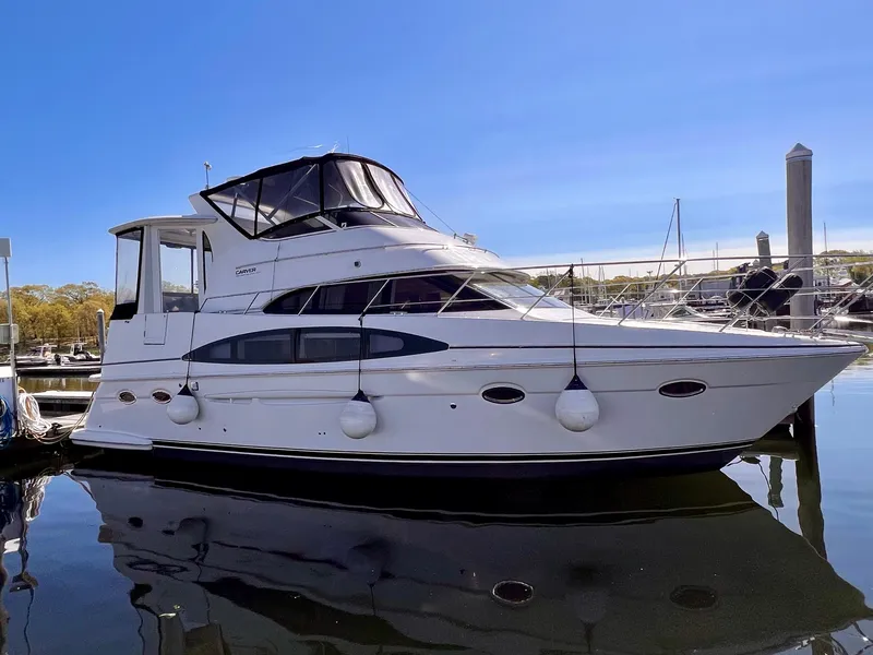 Slide: The Image of 2002 Carver 396 Motor Yacht docked at a marina. - 4