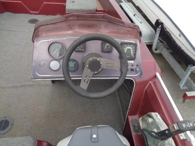 Slide: The Image of 1987 Venture Bass Boat 18 dashboard with steering wheel and gauges. - 10