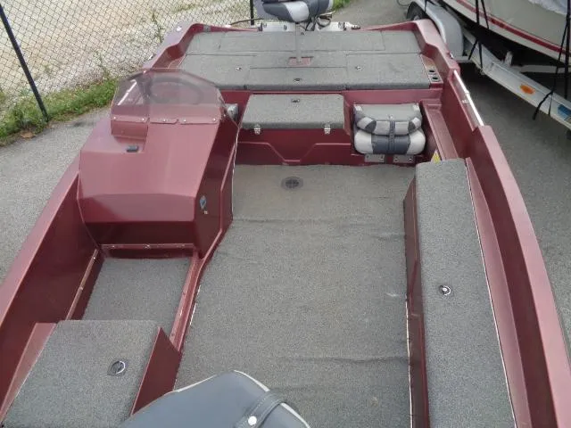 Slide: The Image of 1987 Venture Bass Boat 18 interior, red with gray carpet, spacious layout. - 11