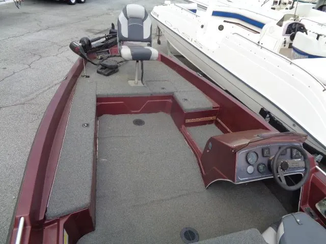 Slide: The Image of 1987 Venture Bass Boat 18 with gray interior and steering console. - 12