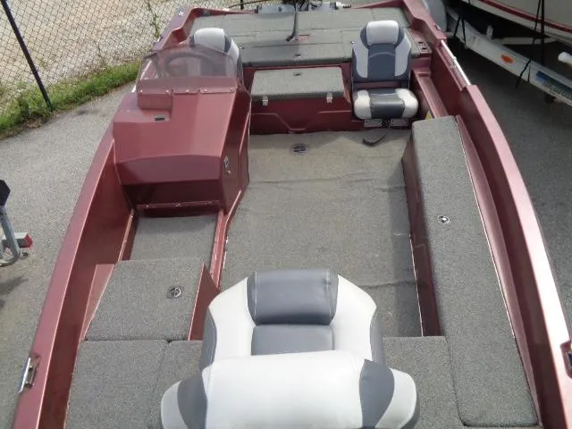 Slide: The Image of 1987 Venture Bass Boat 18 with gray and white seating, red exterior, and spacious deck. - 14