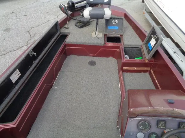 Slide: The Image of 1987 Venture Bass Boat 18 interior with storage compartments and fishing equipment. - 15