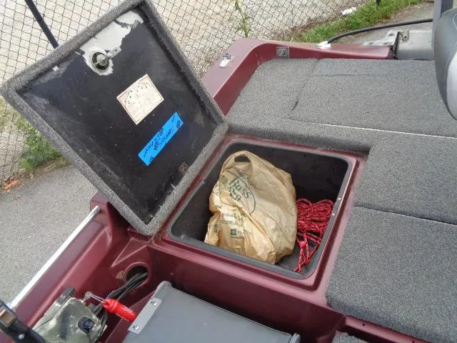 Slide: The Image of 1987 Venture Bass Boat 18 storage compartment with rope and bag. - 18