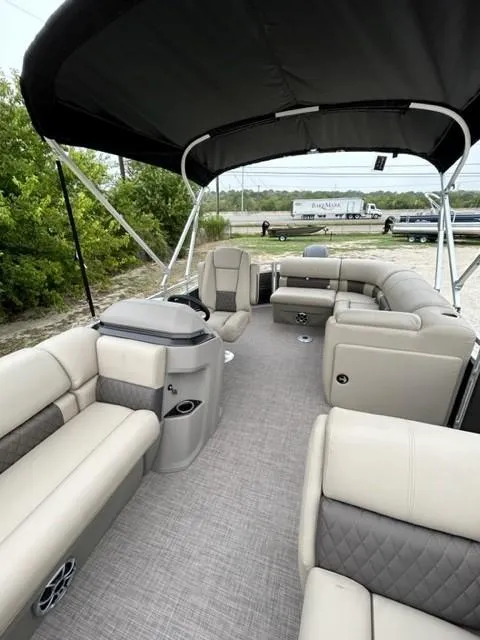 Slide: The Image of 2024 Sun Tracker Party Barge 20 DLX interior with spacious seating and canopy. - 5