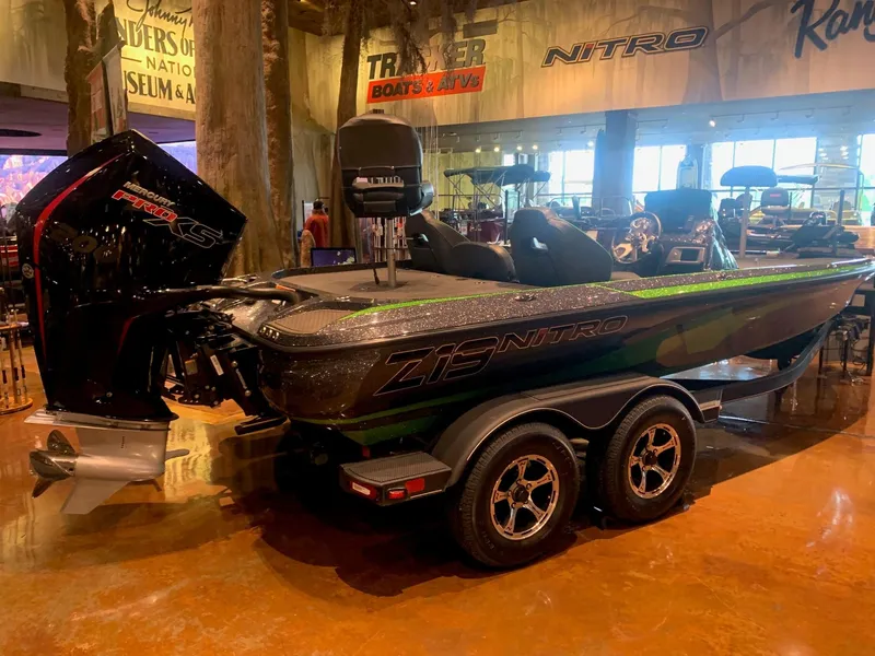 Slide: The Image of 2024 Nitro Z19 Pro boat displayed indoors, featuring sleek design and powerful engine. - 2