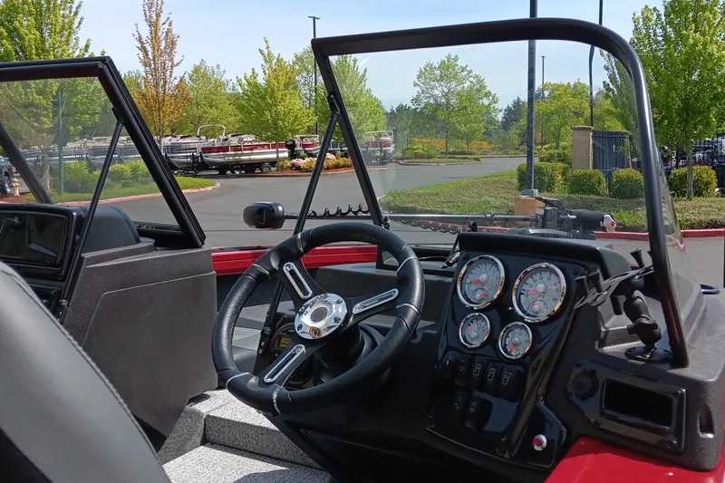 Slide: The Image of 2024 Tracker Targa V-19 Combo boat dashboard and steering wheel. - 2