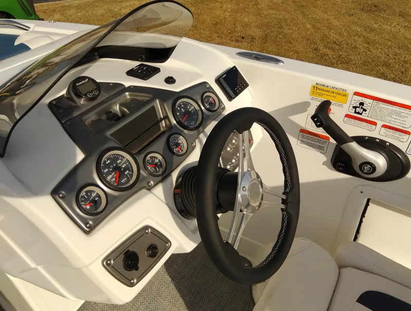 Slide: The Image of 2024 Tahoe 2150 boat dashboard with steering wheel and gauges. - 1