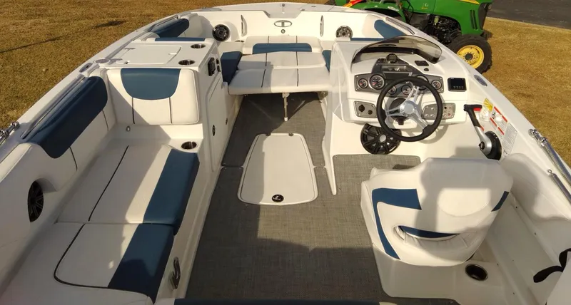 Slide: The Image of 2024 Tahoe 2150 boat interior with seating, steering wheel, and dashboard. - 5